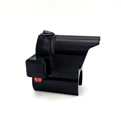 A black plastic 3D-printed mechanical component or part with a small red indicator light, shown on a plain white background.